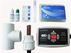 an assortment of medical supplies including a thermometer, pipe and test strips on a white background