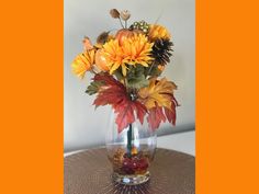 a vase filled with lots of flowers on top of a table