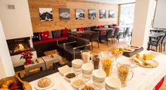 a dining room filled with lots of food on top of a white table covered in plates and bowls