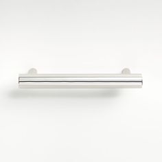 a chrome door handle on a white wall