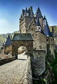 an old castle with stone walls and towers on the top of it's sides