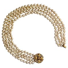 A gorgeous Chanel faux pearl necklace from the ultra-glamorous 1980s. This beauty of a necklace boasts four graduated strands of baroque pearls embellished with an ornately detailed gold medallion clasp. Stamped 'CHANEL, 1983' on the back of medallion. It can be worn with the clasp at the nape of the neck, or lavishly draped around the clasp worn on one side. Definitely, a showstopper. 21.50 inches in overall Length x 1.50 inches Wide. The medallion clasp measures 1.38 inches in Diameter. Very g Chanel Necklace, Gold Medallion, Baroque Pearl Necklace, Chanel Vintage, Faux Pearl Necklace, Multi Strand Necklace, Vintage Chanel, Baroque Pearls, Multi Strand