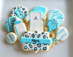 decorated cookies in the shape of baby items