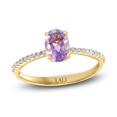 A mesmerizing oval-cut natural amethyst gemstone shimmers with elegance in the center of this gorgeous women's ring from the Lali Jewels Collection. Brilliant round diamonds line the band to complete the look. Fashioned in 14K yellow gold, the total diamond weight is 1/10 carat. Amethyst Engagement Ring, Amethyst Ring Engagement, Diamond Stacks, Jared The Galleria Of Jewelry, Elegant Pendant, Gemstone Engagement Rings, Gold Price, Anniversary Bands, Amethyst Stone