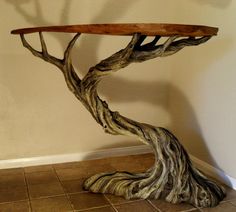 a tree shaped table sitting on top of a tiled floor