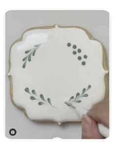 someone is painting the side of a plate