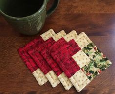 four coasters are sitting on a table next to a coffee cup