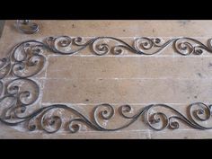 an ornate metal frame sitting on top of a tile floor