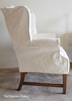 a white chair sitting on top of a carpeted floor