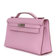 This Kelly Pochette is in Mauve Sylvestre swift leather with palladium hardware and has tonal stitching, front flap, two straps with center toggle closure and a top flat handle.The interior is lined with Mauve Sylvestre lambskin and has an open wall pocket.Collection: UOrigin: FranceCondition: New and never worn (plastic on hardware) Accompanied by: Hermes box, Hermes dustbag, felt, carebook and ribbonMeasurements: 8.5" width x 5" height x 2.5" depth; 1" handle drop Hermes Mauve Sylvestre, Pink Mini Kelly, Hermes Kelly Pochette, Mauve Sylvestre, Pink Shoulder Flap Bag With Gold-tone Hardware, New Swift, Kelly Pochette, Luxury Pink Flap Bag With Gold-tone Hardware, Luxury Pink Bag With Turn-lock Closure