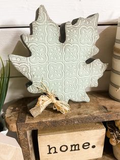 a wooden box sitting on top of a table next to some plants and other items