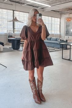 A day in the life of a fashion icon because you in this dress is stunning!!! Dark brown short puff mini dress, tiered style, dress is lined Material is Polyester Hang to dry Model is 5’7 wearing a small SHOP THE LOOK Small Medium Large Length 30” 31” 32” Bust 18” 19” 20” Dress For A Country Concert, Toffee Outfits, Brown Babydoll Dress, Short Dress Cowboy Boots, Brown Fall Dress, Fall Outfits Women Dresses, Cowgirl Boots Outfit Dresses, Cowboy Cocktail Attire, Western Dress Ideas