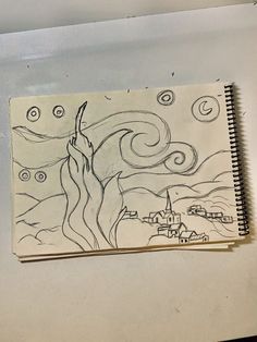 a notebook with a drawing of a woman reaching up into the sky