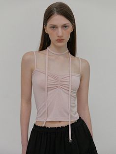 This product features a sleeveless top with an intricate shirring design that brings a textural element to the garment. The unique scarf-like straps create an eye-catching neckline, adding a modern twist to a classic black top. Its cropped cut makes it versatile for pairing with high-waisted bottoms for both casual and dressier occasions. - The top's shirring detail not only adds visual interest but also ensures a flattering fit.- Scarf-inspired straps tie elegantly around the neck, offering a customizable fit and a hint of sophistication.- Made with a stretchable fabric, this top provides comfort and conforms beautifully to the body's shape.- Its cropped length makes it a perfect piece to combine with various separates, enhancing its day-to-night versatility. Feminine Ruched Sleeveless Top, Spring Ruched Camisole Tank Top, Elegant Spring Halter Top With Straps, Elegant Halter Top With Straps For Spring, Elegant Spring Halter Top, Ruched Trendy Tank Top For Spring, Trendy Ruched Tank Top For Spring, Chic Ruched Tank Top For Spring, Elegant Ruched Cami Top