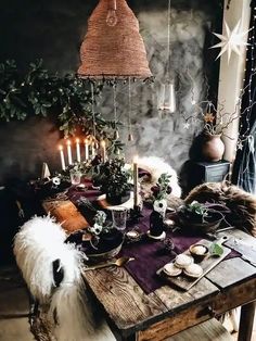 a dining room table with candles, flowers and other decorations on it's side