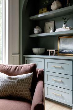 a living room filled with furniture next to a window