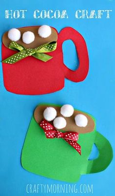 hot cocoa craft with marshmallows in a red cup and green mug on a blue background