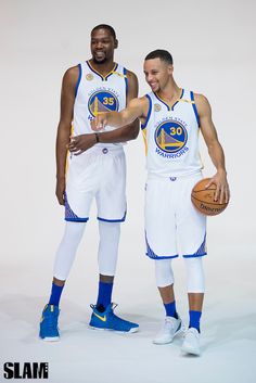 two basketball players standing next to each other