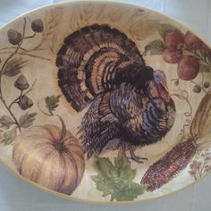 a turkey is sitting on a plate with autumn decorations