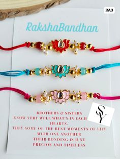 three bracelets with different colors and designs on them, sitting next to each other