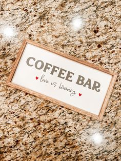 a coffee bar sign sitting on top of a counter