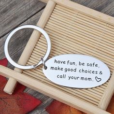 a keychain that says have fun, be safe, make good choices and call your mom