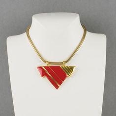 Lovely Lanvin Paris modernist pendant choker necklace. Serpentine gilt metal chain ornates with geometric pendant in shiny gilt metal and red enamel. Spring ring-closing clasp. Signed with a little gilded tag underside the pendant: "Lanvin - Paris." Measurements: total length 15.38 in (39 cm) - pendant: 2.88 in wide x 2.38 in high (7.3 x 6 cm).  Please see the measurements noted above, in the description for the best approximate dimensions. Modern Gold Collectible Jewelry, Modern Gold Jewelry For Collectors, Red Enamel Jewelry With Large Pendant, Formal Red Necklace With Large Pendant, Red Necklace With Large Pendant For Formal Occasions, Formal Red Enamel Necklaces, Red Enamel Collectible Jewelry, Modernist Enamel Jewelry For Gifts, Formal Red Enamel Necklace