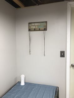 a hospital room with a bed and medical equipment hanging on the wall