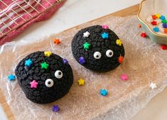 two decorated cookies sitting on top of a table