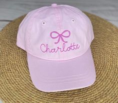 Adorable kids cap Embroidered with a bow and name  Hot pink, light pink and white available  Fits age 2-8 best Adjustable leather strap on back Cute Personalized Baseball Cap With Curved Brim, Personalized Cute Baseball Cap With Curved Brim, Personalized Pink Cap, Pink Curved Brim Hat Personalized, Personalized Pink Snapback Hat, Cute Baseball Cap With Embroidered Logo, Customizable Pink Birthday Hat, Adjustable Pink Baseball Cap For Birthday, Adjustable Pink Baseball Cap Birthday