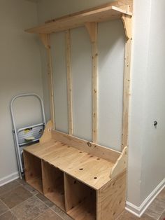 a bench made out of wooden planks in the corner of a room with tile flooring