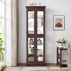 a tall wooden cabinet with glass doors in a living room