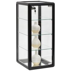 three white vases in a glass case with black trimming on the front and sides