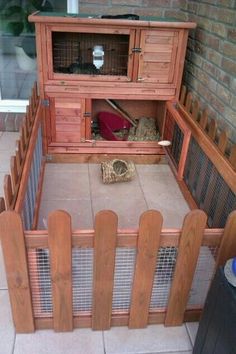 an outdoor rabbit hutch made out of wood