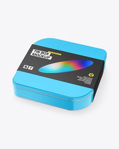 a blue box with a black lid and a rainbow colored object in the top right corner