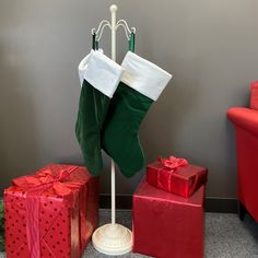 a christmas stocking on a stand next to presents