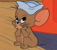 a cartoon mouse sitting on top of a wooden floor