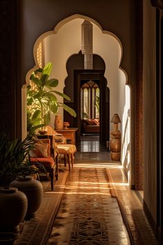 an archway leading into a living room filled with furniture and potted plants on either side