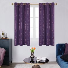 a living room with purple furniture and curtains