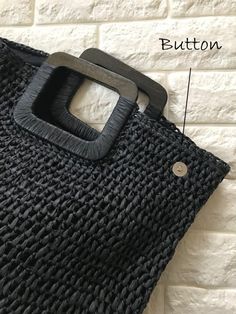 the side view of a black bag with buttons on it and an image of the bottom section