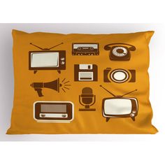 an orange pillow with black and white images of old tvs, speakers, and microphones on it