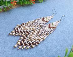 Bohemian bead earrings, beige gold  earrings, seed bead fringe earrings, long bead earrings, boho earrings for women  Materials: Czech beads 10/0, 6/0, stainless steel ear hook Size: Beige: length - 9 cm (3 1/2 inches), width 2,4 cm (1 inches) Transparent gold: length - 11 cm (4 1/2 inches), width 4 cm ( 1 1/2 inches) The color of the live product may differ from the photo depending on the brightness settings of your monitor. 100% handmade, so each subsequent copy may be partially different from the photo Earrings can be made in another color, write to me if you need to change something. You can see these and other works on my Instagram page: mila_kim_handmade Brown Dangle Beaded Earrings For Summer, Beige Bohemian Fringe Earrings, Beige Bohemian Jewelry With Fringe, Bohemian Beige Fringe Jewelry, Handmade Brown Beaded Earrings For Summer, Handmade Brown Beaded Summer Earrings, Handmade Beige Dangle Beaded Earrings, Beige Dangle Jewelry With Colorful Beads, Bohemian Beaded Beige Jewelry