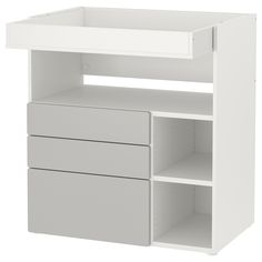 a white shelf with two drawers and one open drawer on the bottom, against a white background