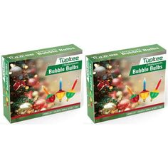 two boxes with candles on them sitting next to each other