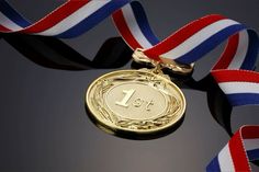 a gold medal with a red, white and blue ribbon around it