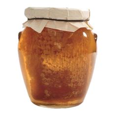 a jar filled with honey sitting on top of a table