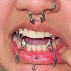 a woman's mouth with multiple metal studs on it