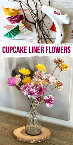 cupcake liner flowers in a glass vase on a wooden stand with the words cupcake liner flowers