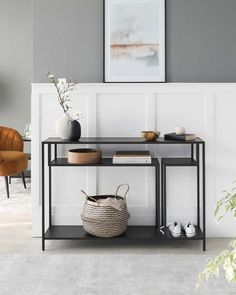 a modern console table with baskets on it