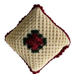 a crocheted square with a flower on it